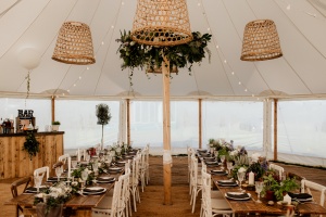 A marquee wedding set up in rustic style