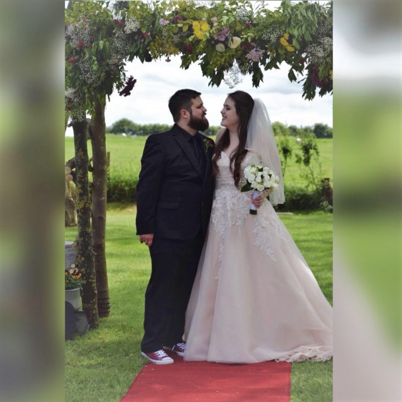 Bride and groom standing in the archway