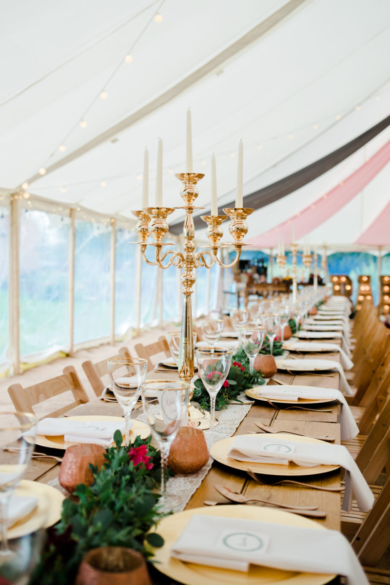 marquee top table set up with golden charger plates